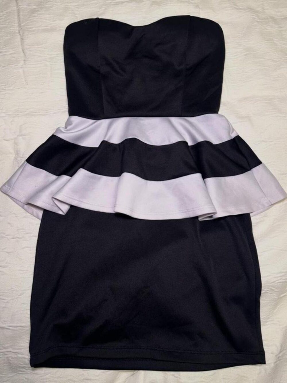 Black and white strapless dress with ruffle skirt